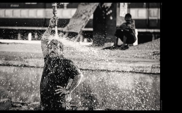 Book cover of Phil Penman: Street Scenes; featuring a figure walking across a misty street with traffic lights on red. Published by teNeues Books.