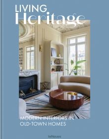 Book cover of Living Heritage: Modern Interiors in Old-Town Homes; with an interior living room with curved sofas and fireplace. Published by teNeues Books.