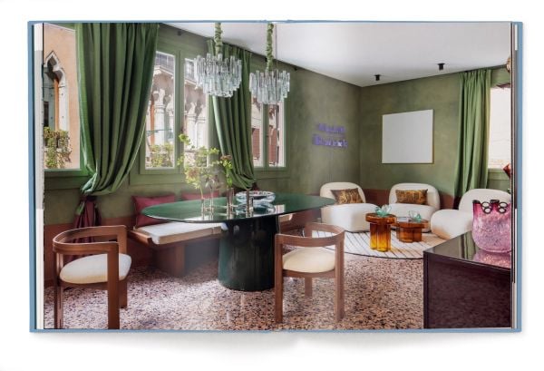 Book cover of Living Heritage: Modern Interiors in Old-Town Homes; with an interior living room with curved sofas and fireplace. Published by teNeues Books.