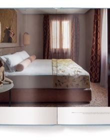 Book cover of Living Heritage: Modern Interiors in Old-Town Homes; with an interior living room with curved sofas and fireplace. Published by teNeues Books.