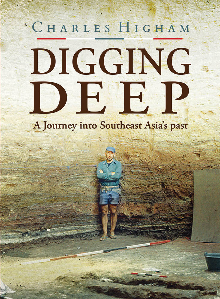 Book cover of Digging Deep: A Journey into Southeast Asia's past, with the British archaeologist in blue shirt and denim shorts, standing in excavated ground, high wall behind. Published by River Books.
