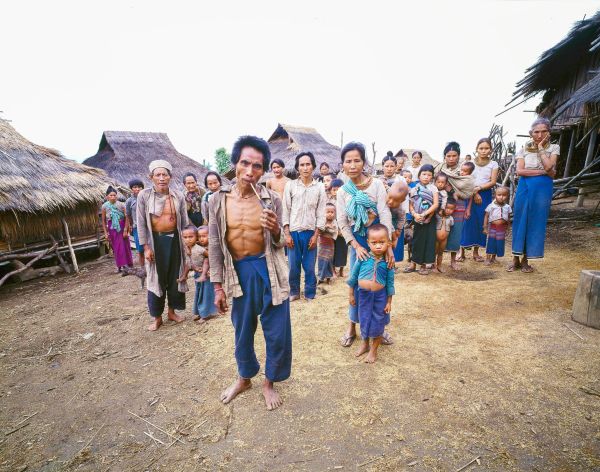 Book cover of Tai: A Woven Culture, with rice fields with workers in colourful clothes smiling at camera. Published by River Books.