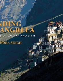 Breath taking photograph of white building complex up a mountainous landscape, Finding Shangri-La in orange font