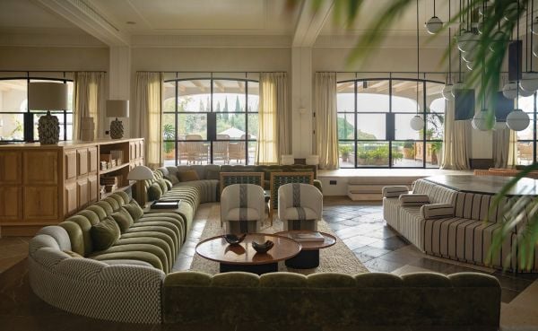 Book cover of Luisa Olazábal: LO·2 Studio, featuring an interior living space with wood table and chairs, and a curved cupboard. Published by Ediciones El Viso.