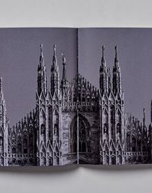 Book cover of Milan; featuring a large, arched stone gate. Published by Helmin & Sorgenfri.