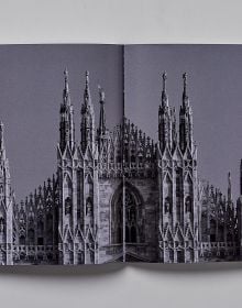 Book cover of Milan; featuring a large, arched stone gate. Published by Helmin & Sorgenfri.