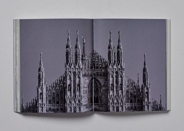 Book cover of Milan; featuring a large, arched stone gate. Published by Helmin & Sorgenfri.