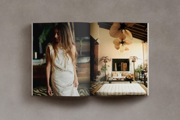 Book cover of Barefoot Living; featuring a rustic, minimalist interior with arch window and ceiling beams. Published by Helmin & Sorgenfri.