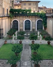 Courtyard of the Palazzo Medici Riccardi, marble sculpture of Orpheus with three-headed dog Cerberus, PALAZZO MEDICI RICCARDI in green font on top white banner above.