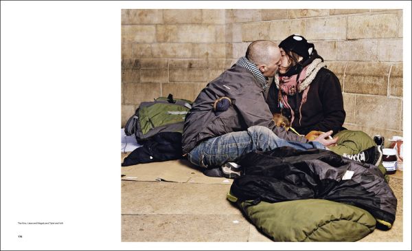 Book cover of Andres Serrano; with a homeless man laying under cardboard. Published by Silvana.