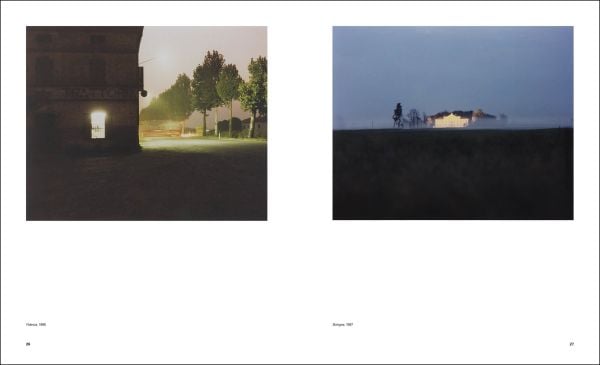 City square with buildings under night sky, blue cover, Luigi Ghirri Thought Landscapes in blue and white font above