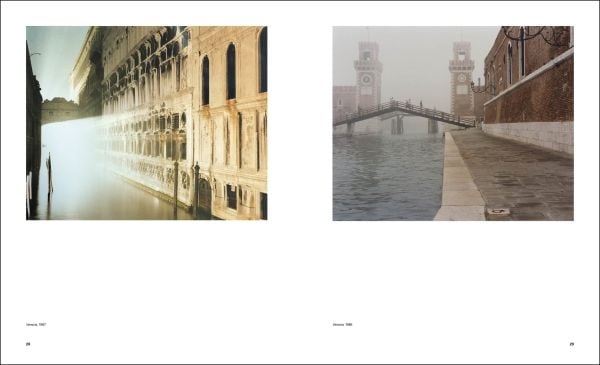 City square with buildings under night sky, blue cover, Luigi Ghirri Thought Landscapes in blue and white font above