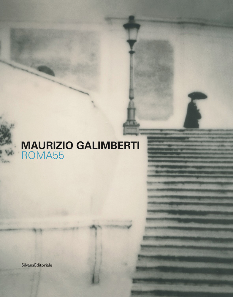 Black silhouette of figure holding umbrella at top of city steps, street lamp, MAURIZIO GALIMBERTI ROMA55 in black and blue font to left of centre