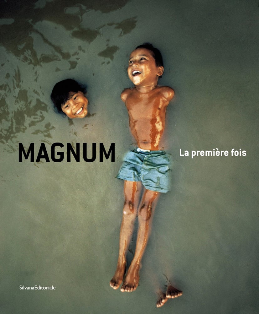 Book cover of Magnum: La première fois; with two children playing in a river. Published by Silvana.