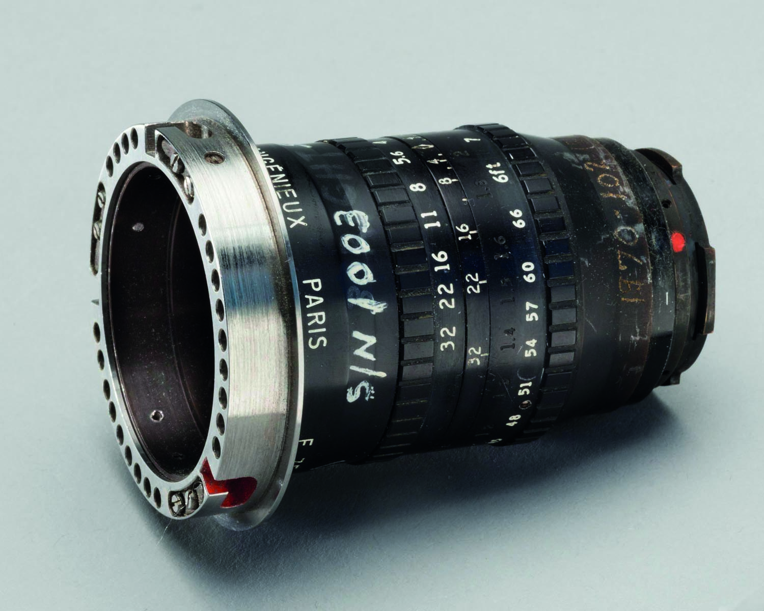 Large camera lens with video equipment, red filter, ANGENIEUX AND CINEMA From Light to Image in white and yellow font below