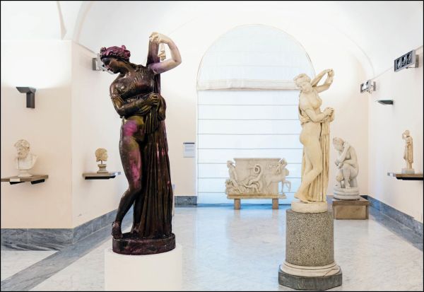 Performance art scene with explosive orange fire and white smoke, CAI GUO-QIANG AND POMPEII In the Volcano in white font to centre.