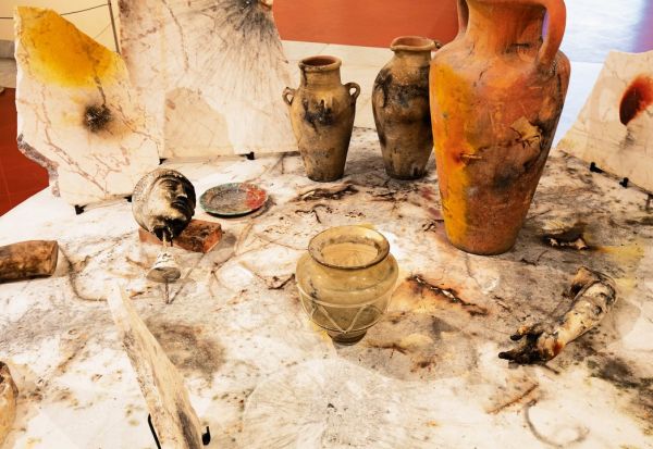 Performance art scene with explosive orange fire and white smoke, CAI GUO-QIANG AND POMPEII In the Volcano in white font to centre.
