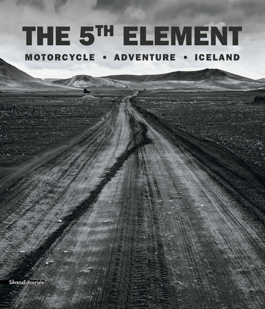 Book cover of The 5th Element: Motorcycle. Adventure. Iceland, with a vast Icelandic mountainous landscape with dirt trail below. Published by Silvana.