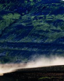 Book cover of The 5th Element: Motorcycle. Adventure. Iceland, with a vast Icelandic mountainous landscape with dirt trail below. Published by Silvana.