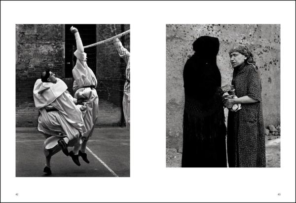 Black and white shot, People of Emilia, Emilia-Romagna 1959, 3 males seated outside café with motorcycle, NINO MIGLIORI in white font to top right.