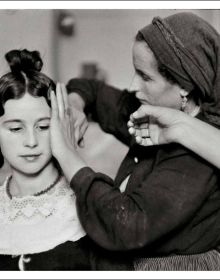 Book cover of Inge Morath; featuring a self portrait photograph of the photographer holding camera. Published by Silvana.