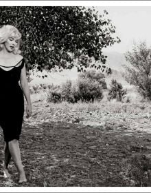 Book cover of Inge Morath; featuring a self portrait photograph of the photographer holding camera. Published by Silvana.