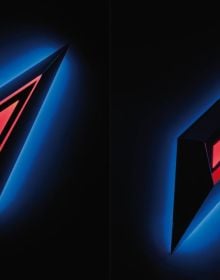 Violet blue screens with illuminated edges, nanda vigo light project in white neon style lighting font to lower portion.