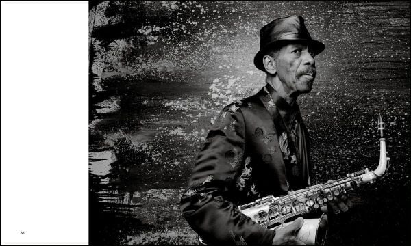 Louie Armstrong with eyes closed, holding trumpet in right hand, left index finger to mouth, JIMMY KATZ CLOSED SESSION in orange font to upper left.
