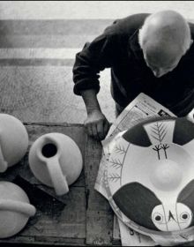 The four season ceramic vase by Pablo Picasso with back of nude female figure on front, grey cover, PICASSO The challenge of ceramics in orange and white font to centre left.