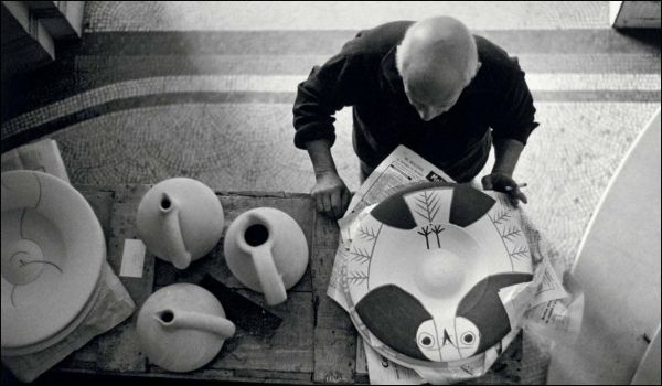 The four season ceramic vase by Pablo Picasso with back of nude female figure on front, grey cover, PICASSO The challenge of ceramics in orange and white font to centre left.