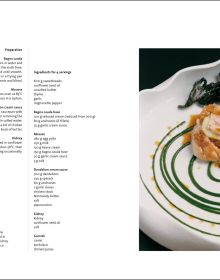 Aerial view of wavy edged bowl filled with broad bean risotto with herb leaves on top, black cover, COOKING WITH ANTONIO GUIDA in white font above.