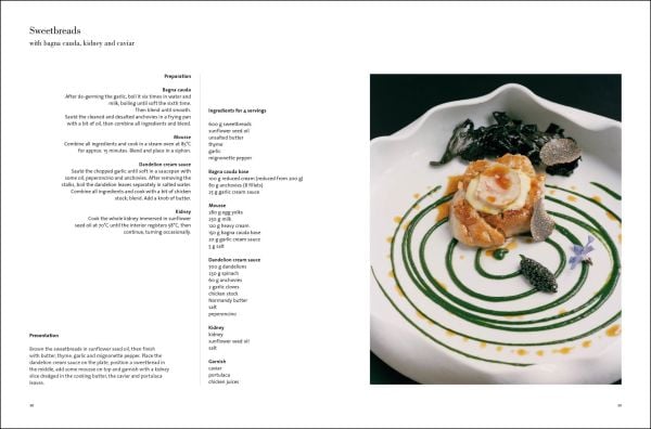 Aerial view of wavy edged bowl filled with broad bean risotto with herb leaves on top, black cover, COOKING WITH ANTONIO GUIDA in white font above.