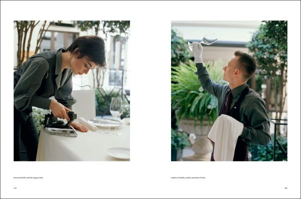 Aerial view of wavy edged bowl filled with broad bean risotto with herb leaves on top, black cover, COOKING WITH ANTONIO GUIDA in white font above.