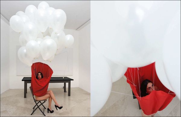 Mangiafuoco, 1979 by Pier Paolo Calzolari, man breathing fire into red canvas, Pier Paolo Calzolari Painting as a Butterfly in white font above.