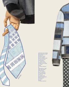 Close up shot of left lapel and collar of blue and black denim jacket, Blue Tailoring Stefano Chassai in white and blue font to left edge.