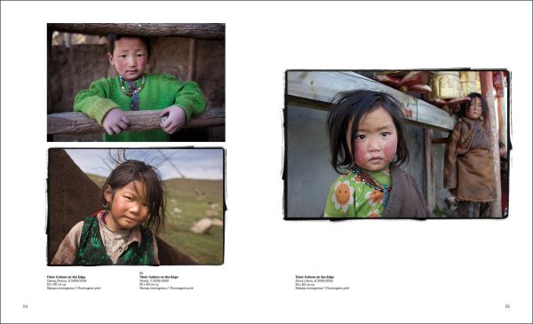 Two small children, one seated on table and one peering over, in grey woollen clothes and white cap with Phil Borges in white font above