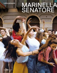 Book cover of Marinella Senatore, with a group of dancers in town square, one in white tutu. Published by Silvana.