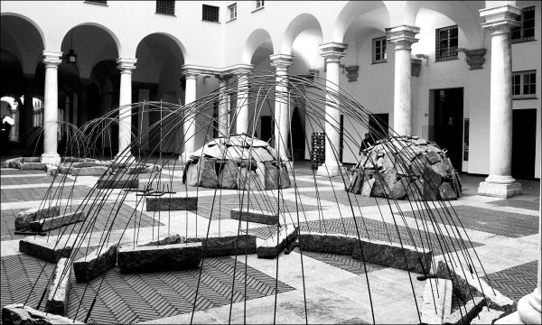 Blue filter photo of interior museum with Germano Celant The Story of (my) Exhibitions in blue and white font