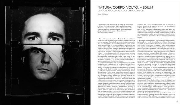 Blurred, grainy black and white photo of 2 faces touching, with eyes closed and Paolo Gioli in yellow font above