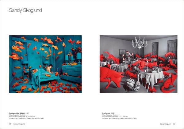 Film still of man, chin deep in water, white building with tower looming over him, True Fictions in white font to upper right.