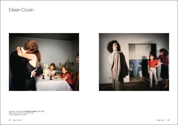 Film still of man, chin deep in water, white building with tower looming over him, True Fictions in white font to upper right.