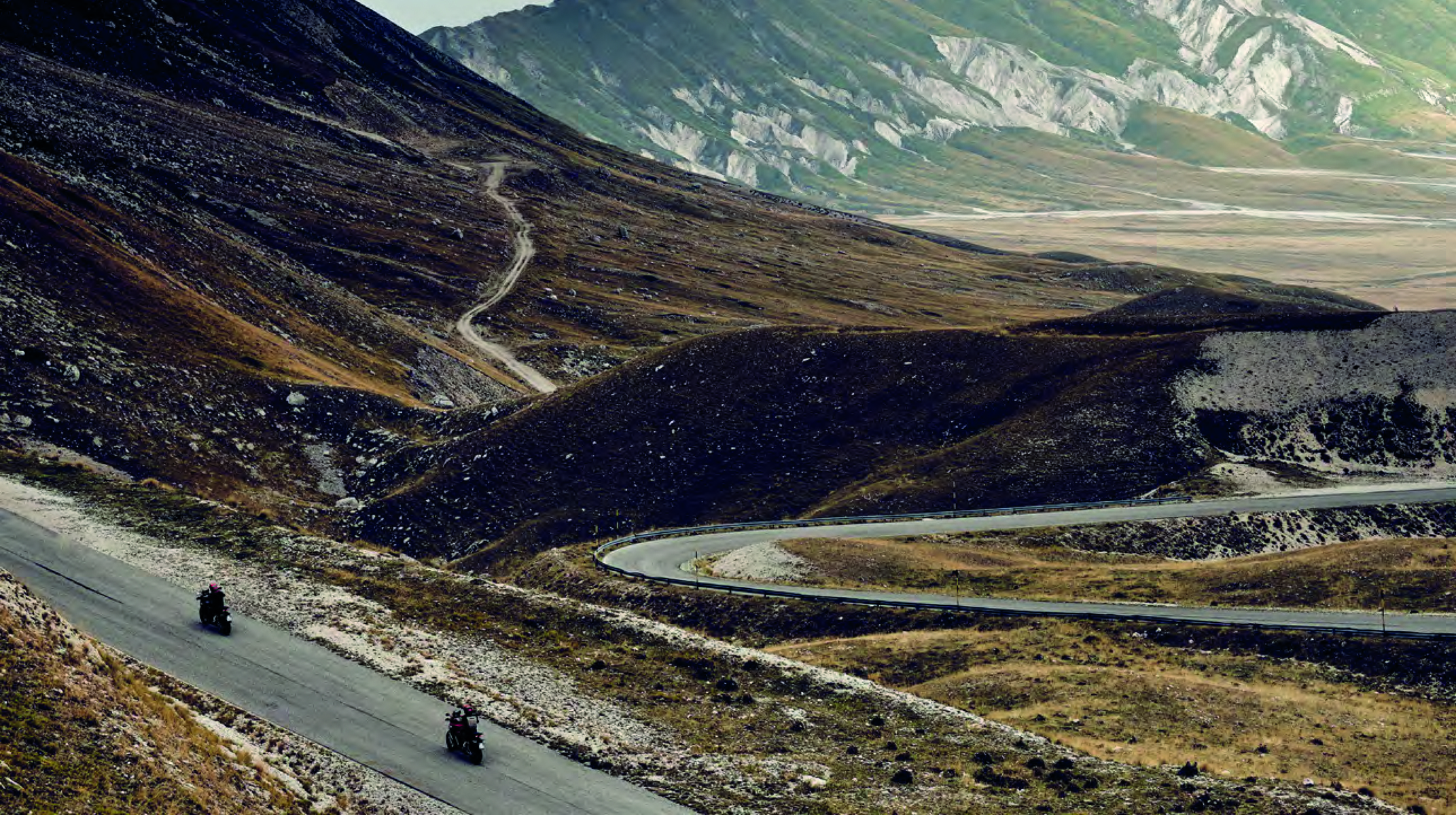 2 Ducati motorcycles travelling on Italian mountain road with Ducati Rule All Roads A Journey across the Italian Beauty on the Multistrada V4 in red and black font above