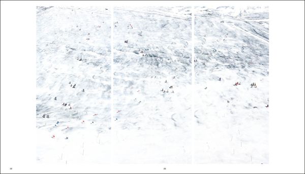 Land covered in cracked snow and ice with small boats and ships floundering on surface with Walter Niedermayr - Transformations in black font above