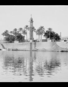 Female figure walking near the Freedom Monument in Baghdad, Iraq, 'BAGHDAD, EYE'S DELIGHT, in white, and red font to bottom edge.