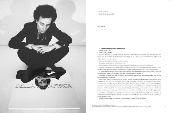 Book cover of Paolo Scheggi, with the Italian artist wearing a suit, standing in a studio surrounded by his elliptical holed canvases. Published by Silvana.