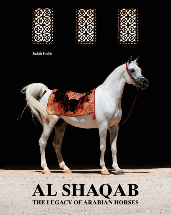 Book cover of Al Shaqab: The Legacy of Arabian Horses, with a white horse with a colourful rug on its back. Published by Silvana.