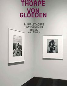 Book cover of Mapplethorpe/Von Gloeden: Beauty and Desire, featuring two black and white portrait photographs, framed on exhibition wall. Published by Silvana.