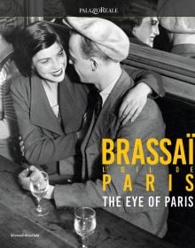 Book cover of Brassaï: The Eye of Paris, with a laughing couple sitting in a bar drinking wine. Published by Silvana.