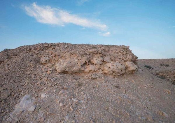 Book cover of Olafur Eliasson: The Curious Desert, with the desert floor seen through an optical device. Published by Silvana.