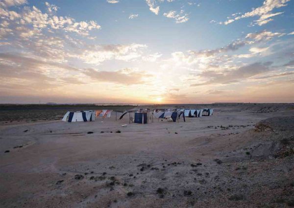 Book cover of Olafur Eliasson: The Curious Desert, with the desert floor seen through an optical device. Published by Silvana.